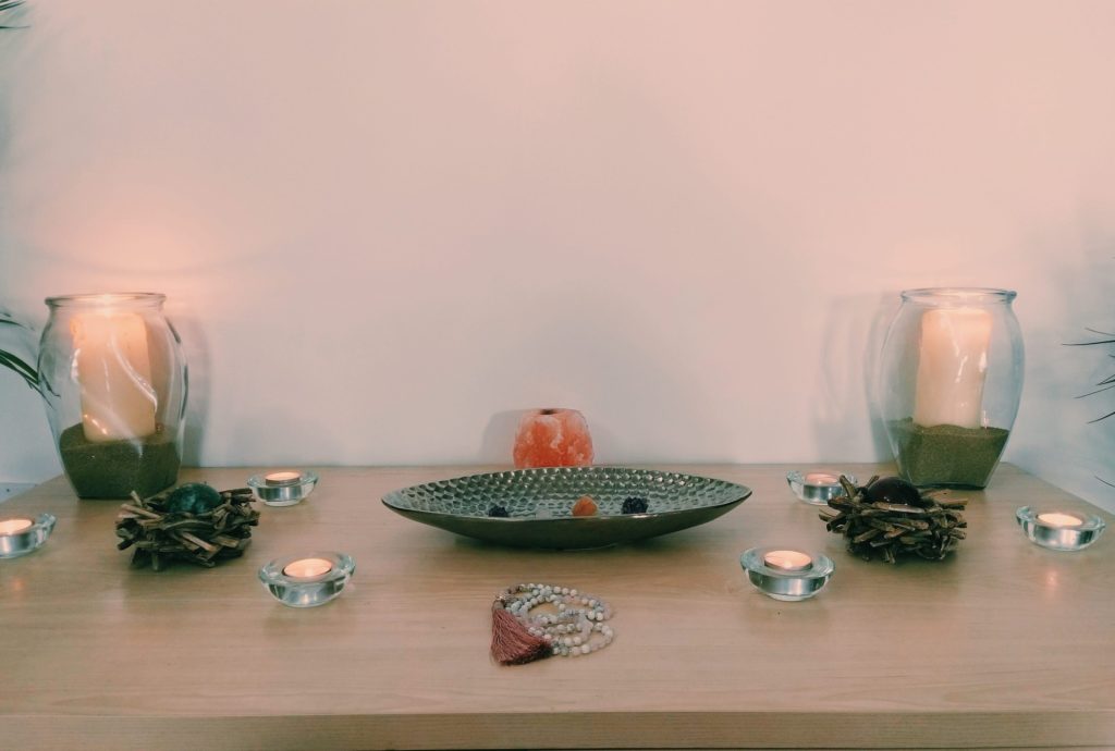 Meditation space with candles, stones, and plants