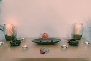 Altar with candles and mala for meditation space