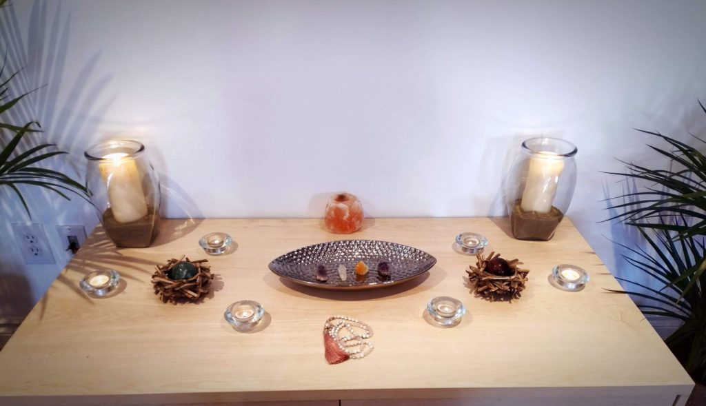 Meditation space with candles, Mala, and stones