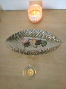 Candles and dish with stones and crystals for meditation space