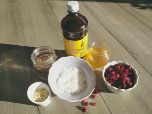 Quinoa, coconut, cranberries, almonds, honey and vanilla to make hot cereal 