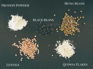 Lentils, quinoa flakes, mung beans, protein powder, and black beans with white text label.
