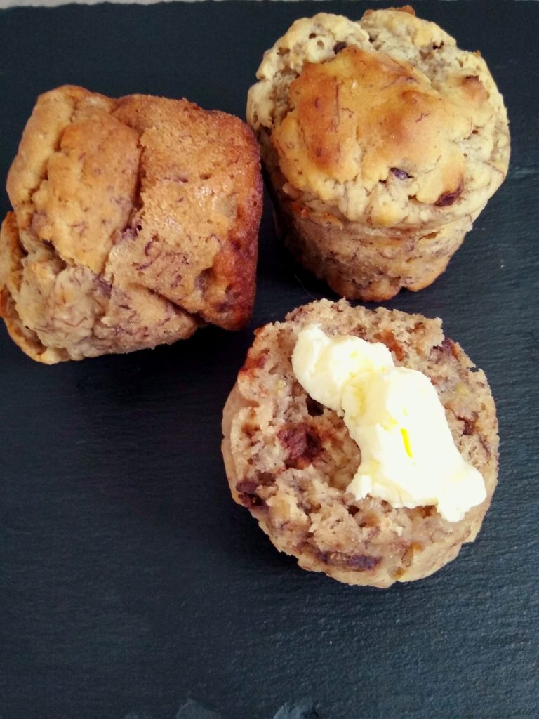 Banana chocolate chip muffins with butter.